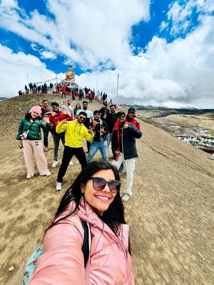 A selfie capturing the whole group on a hillside in Spiti, with the Langza Buddha visible in the background. These are the memories that last a lifetime.