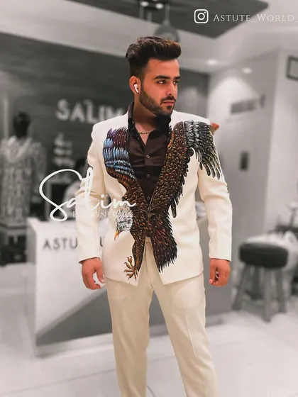 A client wearing a custom white suit with a hand-painted eagle design. The wings are strategically placed to create a sense of motion and power.