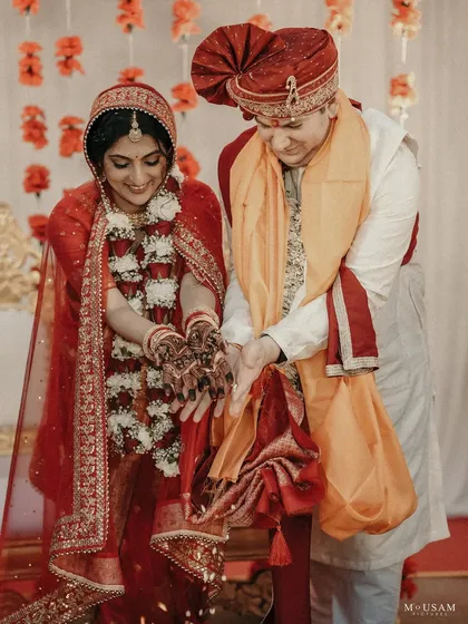 An intercultural couple during their Hindu wedding ceremony. This frame captures the beautiful blend of traditions as they perform the rituals together, their two stories becoming one.