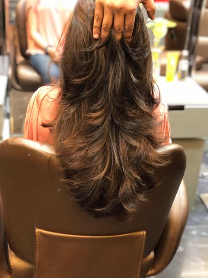 A similar multi-layered haircut, showing how the layers cascade down the back to create a textured look.