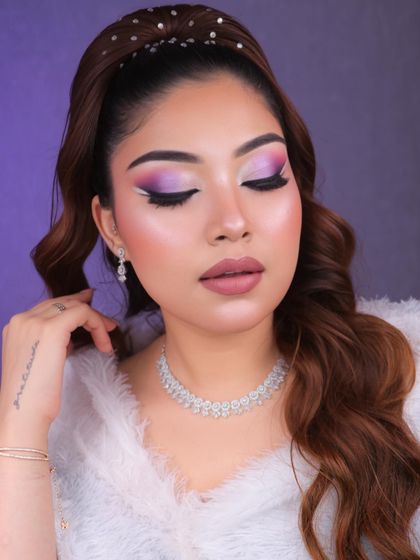 Dive into a world of glam and creativity with this purple and pink graphic eye makeup. The white liner detail adds a futuristic touch, perfect for a creative portfolio.
