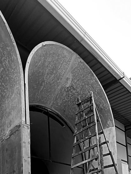 A close-up of the raw, unfinished concrete arches on site. This image captures the texture and form of the architectural elements before the final finishing is applied.