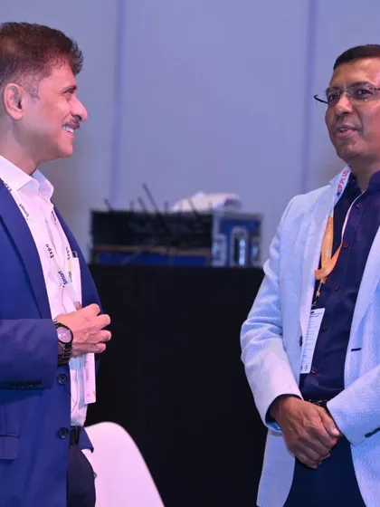 Professionals engaging in a conversation during a conference session break. The expo offers numerous formal and informal settings for valuable industry networking.