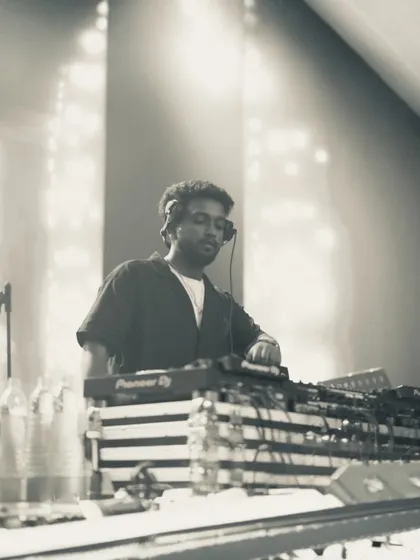 A serene, black and white photo capturing a moment of focus. Even in the loudest environments, there's a calm in being in control of the music.