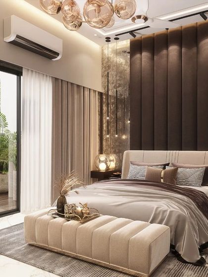 A modern bedroom in a Rohtak residence, featuring a textured, metallic-finish accent wall behind the bed. Pendant lights hang low, creating an intimate ambiance, while a sliding glass door opens to a private balcony, blending indoor comfort with outdoor access.