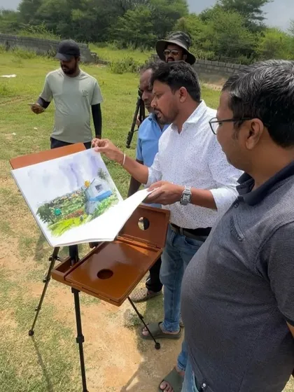 Showing my finished painting to fellow artists who were also painting on location. It's great to share feedback and see different interpretations of the same scene.