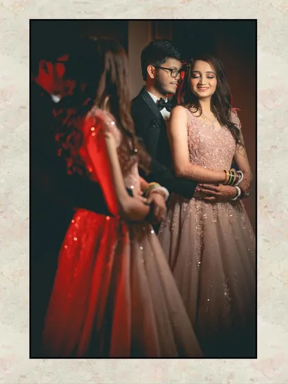 A creative reception portrait using a reflection to add depth and artistry. The couple is seen in a mirror, creating a frame within a frame that feels both intimate and elegant.