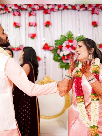 Pure joy and celebration. This candid shot captures the bride's happiness, with her makeup looking flawless and radiant as she enjoys her engagement party.
