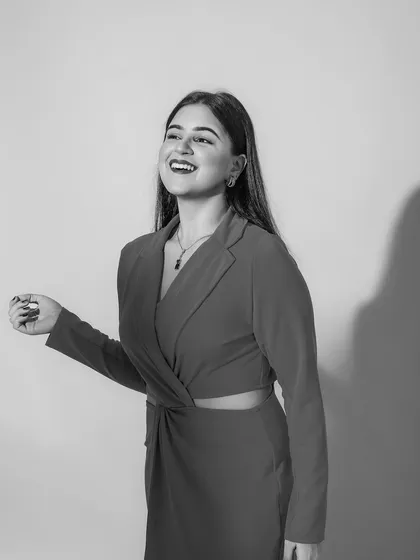 A black and white version of the shot, which emphasizes the joyful expression and the clean lines of the makeup.