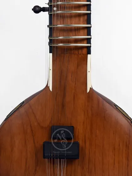 The front of the Zen+ sitar, showing the clean wood finish and a simple pickup. This model is for players who want a modern aesthetic with a classic sound.