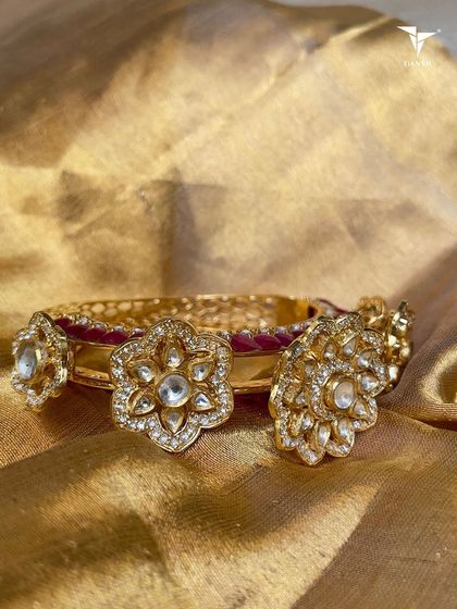 This floral polki and ruby bangle is for moments when you want to show up with tradition and an edge. The uncut polki flowers are set against a backdrop of rich ruby-colored enamel.