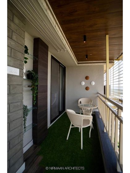 Another view of the bedroom balcony, showing the comfortable seating and the view. We design these spaces to be functional, private, and perfect for relaxation.