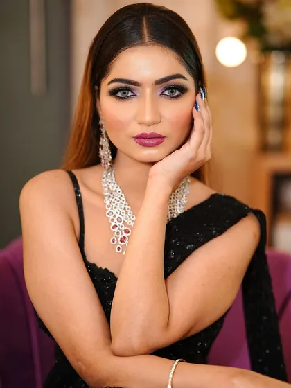 A close-up portrait showing the intensity of the eye makeup and the flawless contouring.