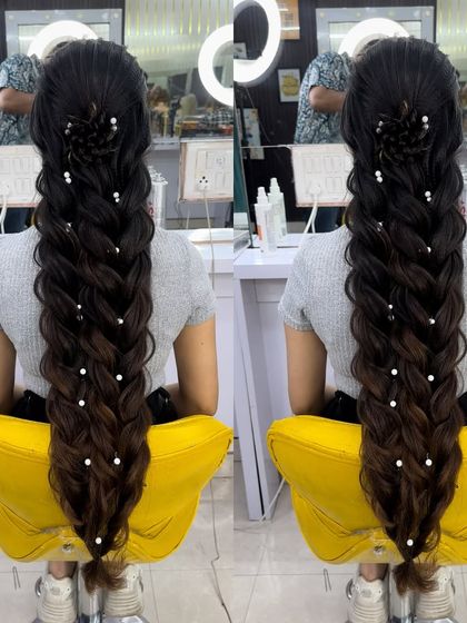 A stunning, long fishtail braid with an ombre effect, decorated with pearls.