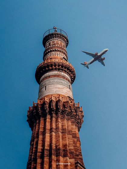 A perfectly timed shot of an airplane flying past the Qutub Minar in Delhi. This photo juxtaposes the ancient and the modern, a theme that defines this historic city.