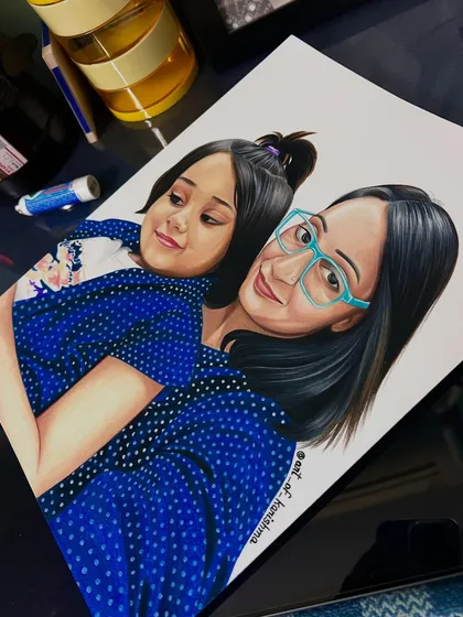 A custom mother-daughter portrait, seen here on my work desk. This 9x12 inch sketch was made with a full set of 72 Prismacolor pencils on smooth Strathmore paper to ensure the colors are bright and the art lasts a lifetime.
