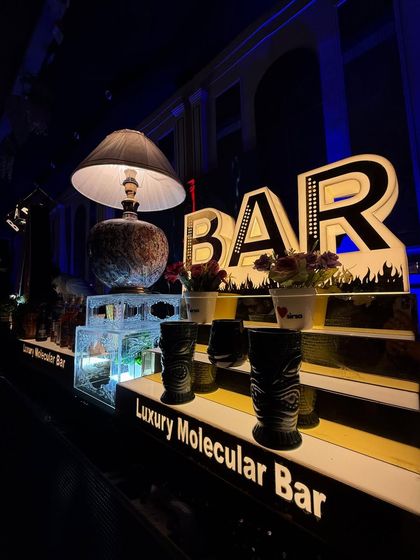 Another angle of our 'BAR' sign and tiki mugs, showcasing the eclectic and detailed props we use.