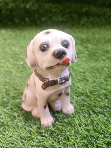 A cute Dalmatian puppy figure, perfect for adding to a dog lover's collection.