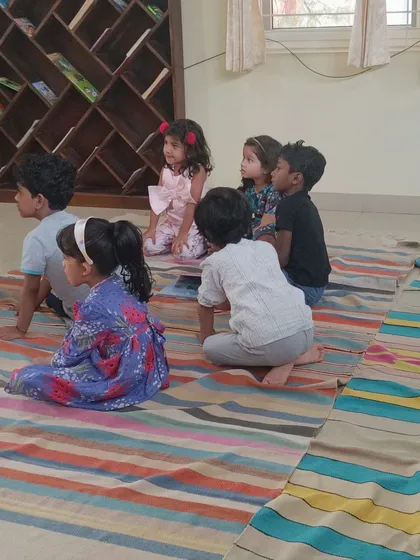 The children are seated in a semi circle, ensuring everyone has a good view of the storyteller.