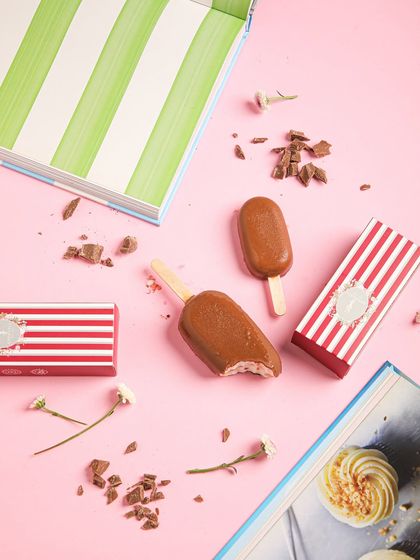 Our chocolate-coated ice cream bars, a classic treat for a sunny afternoon, shown with our new striped packaging.