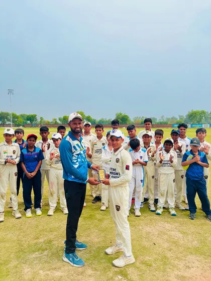 Lakshya receiving the Player of the Match trophy for his fantastic all-round performance. The whole team is there to cheer him on.