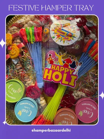 A beautiful festive hamper tray packed for Holi. It's loaded with dry fruits, gulal, water balloons, and other essentials for a fun filled celebration.