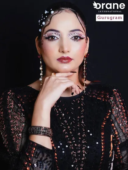 A full portrait of the pearl glam look. The dark, glossy nails and lips provide a beautiful contrast to the shimmering pearls.