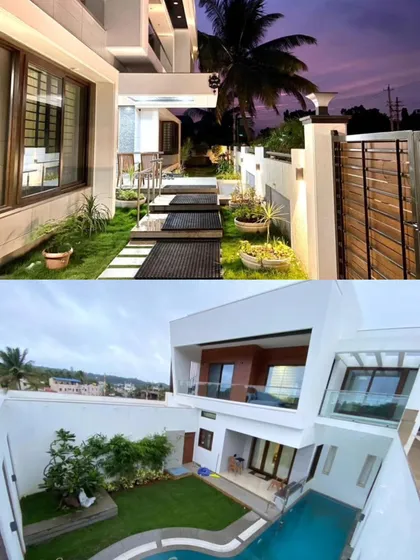 The home's design includes multiple landscaped areas and a pathway that leads from the gate to the entrance, creating a journey through greenery.