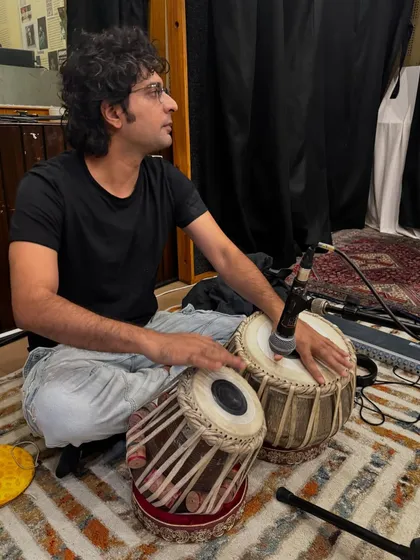 A focused moment during the jam session in Kolkata. You can see the professional microphone setup I use to capture the nuanced sounds of the tabla even in a multi-instrument environment.