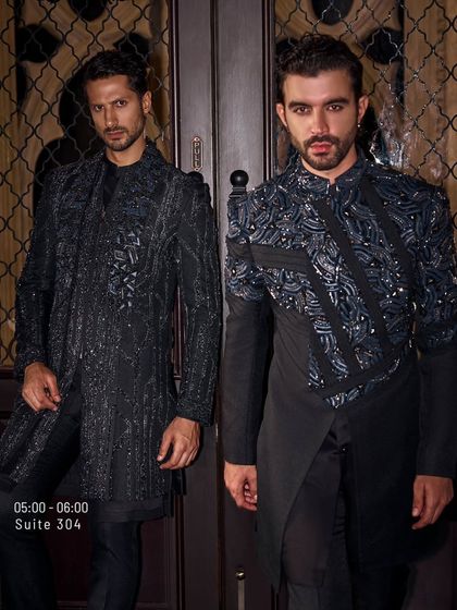 Two variations on a theme: black-on-black, hand-embroidered jackets. One features a full zip, the other an asymmetrical cut, but both share a language of modern, masculine elegance.