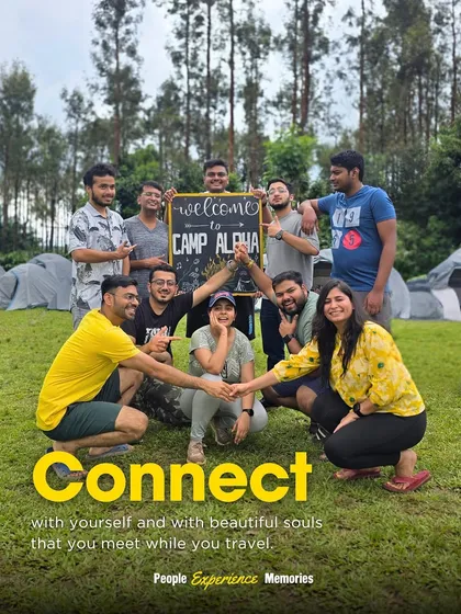"Connect with yourself and with beautiful souls." A group poses with a "Welcome to Camp Alpha" sign, highlighting the community and camping aspect of our trips.