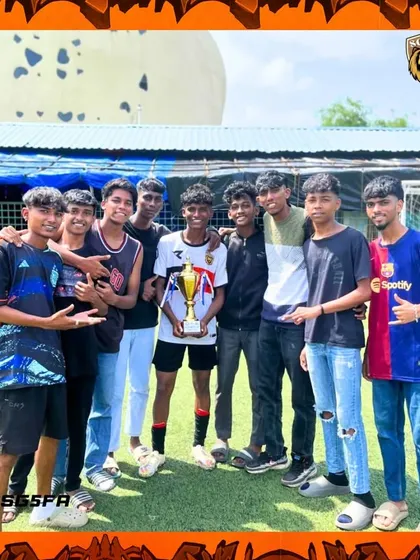 Young supporters holding the trophy. We are inspiring the next generation of players who look up to our teams.