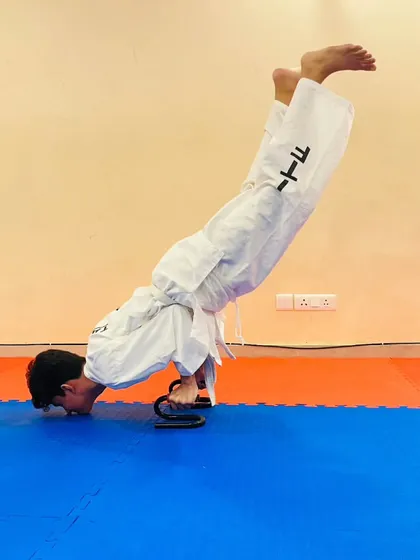 Another angle of the advanced push up exercise, highlighting the form and control required. We push our students to go beyond their limits.
