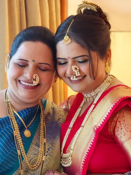A lovely mother-daughter duo, both looking radiant in their traditional Marathi attire. It's always special to get multiple generations ready.