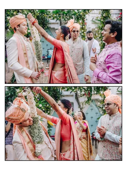 A closer look at the competitive spirit of the Jaimala ceremony. The bride triumphantly places the garland on her groom, surrounded by the smiling faces of their loved ones.