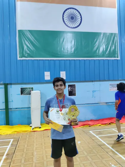 Aryan Chaudhary posing with his gold medal trophy after winning the Boys Singles U-12 category at the Smash to Play open tournament.