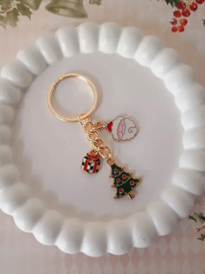 A custom Christmas keychain with a Santa moon, a gift box, and a Christmas tree charm. A perfect personalized holiday keepsake.
