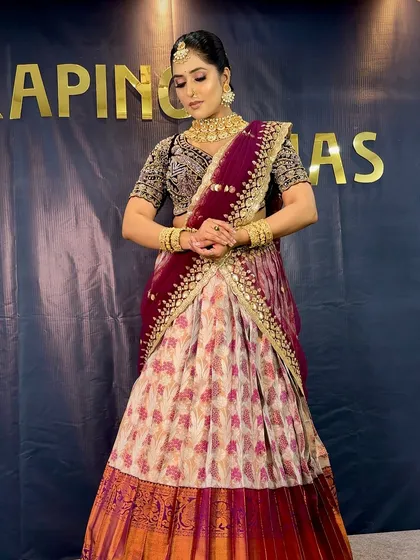 The South Indian half saree is a timeless expression of grace. Here is a complete look we created, showcasing how to perfectly balance the skirt, blouse, and the draped dupatta for a regal and elegant appearance.
