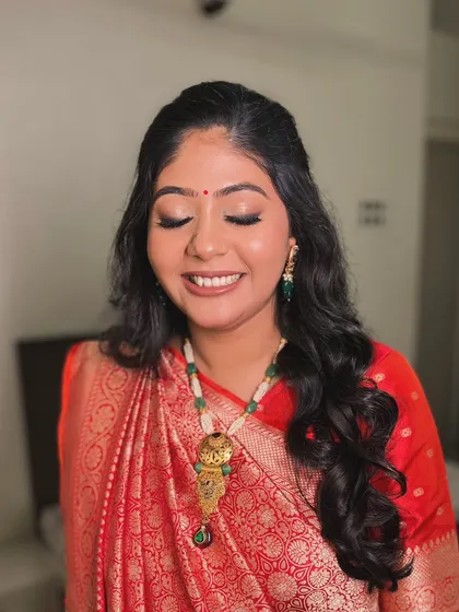 A close-up of the makeup, featuring soft smokey eyes and a radiant smile. She looks absolutely beautiful and ready to be showered with love.
