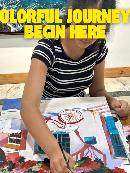 Colorful journeys begin here. A young student works on her painting of a bicycle against a vibrant wall, learning about perspective and color.