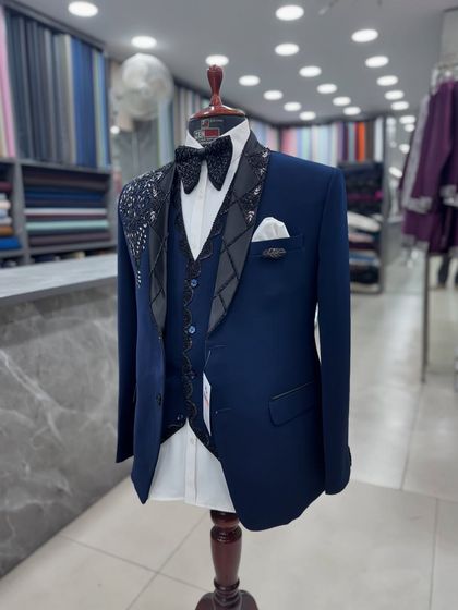 This angle of the navy blue tuxedo shows its sharp tailoring and modern silhouette. It's a perfect example of my commitment to creating suits that are both stylish and perfectly fitted.