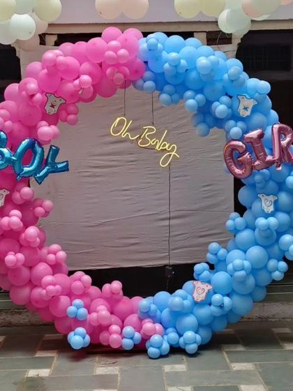 A "Boy or Girl" themed baby shower ring in bright pink and blue, with an "Oh Baby" gold sign.