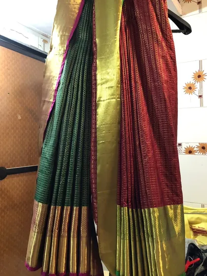 For this client, we created a unique double drape look with two sarees. This style requires careful pleating and setting, which we handled to create a seamless and artistic final appearance.