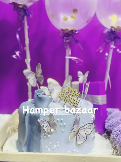 The custom cake with butterfly toppers and confetti balloons makes this a truly special celebration hamper.