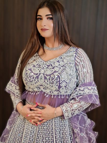 A full view of this stunning party look. The purple lehenga and glass finish makeup are a perfect match.