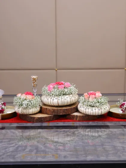 A close-up of the centerpiece created during the Trovea's workshop. We used beautiful ceramic planters, fresh flowers, and wooden log slices to create a rustic yet elegant look.
