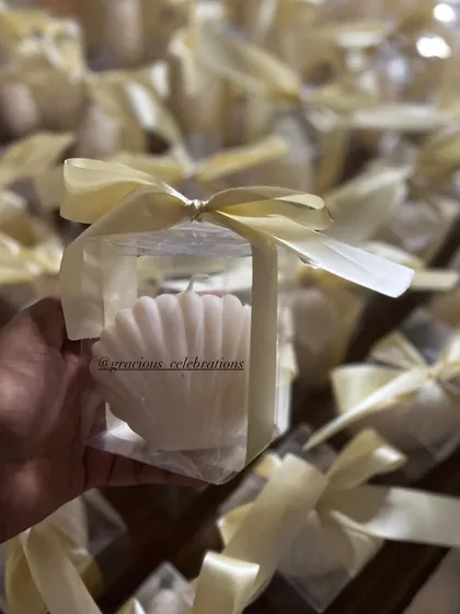 Our shell-shaped candle in individual box packaging. It's a beautiful and unique favor, perfect for beach-themed weddings or engagements.