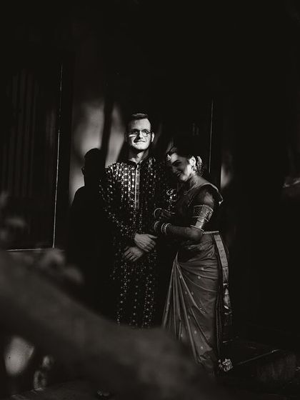 A dramatic black and white portrait of a couple, the shadows and light creating a mysterious and romantic mood.