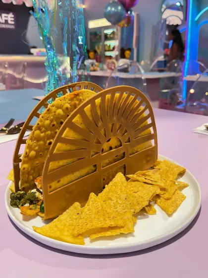An oversized taco served in a custom, sun-shaped holder, designed for our Luxe Café. We believe in making food interactive and memorable, even in a casual café setting.