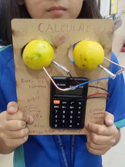 Who knew lemons had so much power? This student is holding a calculator powered entirely by lemons, a fantastic hands-on demonstration of how batteries and circuits work.